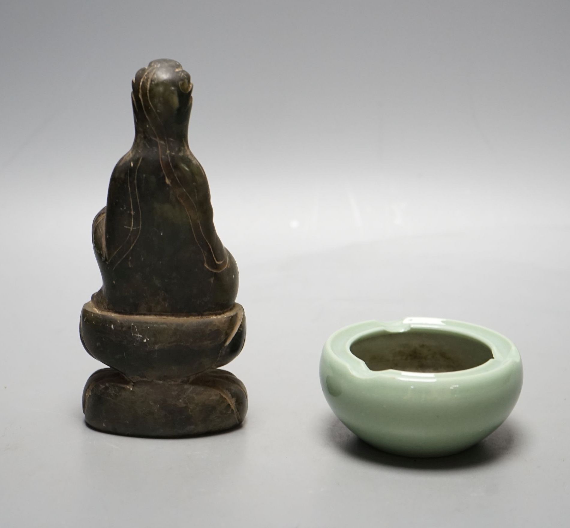 A Chinese soapstone carving of Buddha and a celadon glazed bowl, Buddha 16.5 cms high.